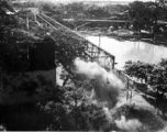 Bombing on Phu Lang Thuong railway bridge over the Thuong River at Bắc Giang City in French Indochina (Vietnam), during WWII. In northern Vietnam, and along a critical rail route used by the Japanese.  Coordinates:  21°16'32.69"N 106°11'9.28"E  This photo shows the truly extraordinarily low levels the bombing B-25s sometimes flew at times during missions.