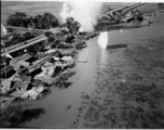 Bombing of small rail bridge, among a flood plain, in French Indochina during WWII.