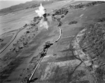 Bombing of small rail bridge, among a flood plain, in French Indochina during WWII.