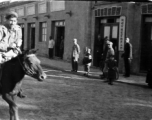 American Navy GI riding a mule in a small town in Northern China, Shaanba Town, Inner Mongolia.  内蒙陕坝市。