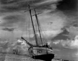 Boat 'Icaros" ground on the sandy shore in India.  Scenes in India witnessed by American GIs during WWII. For many Americans of that era, with their limited experience traveling, the everyday sights and sounds overseas were new, intriguing, and photo worthy.