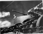 Man with microphone in gun emplacement on transport ship home from CBI to US after WWII.