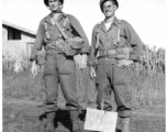 Two GIs in combat gear, either in in China, or possibly at Camp Swift, Texas during training. During WWII.  Curiously, the sign in the ground in front of them says "Dew Drop In."