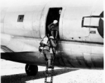 Chinese soldiers climb down ladder out of C-46 transport plane. During WWII.