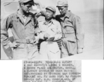 At the Tengchong cutoff: T/4 Lorne C. McEwen, a convoy driver, is seen being interviewed by Chinese war correspondent Mr. Fu Gang-bor, as fellow driver Sgt. G. N. Cumberland looks on.  Yunnan Province on March 4, 1945.  Photo by T/Sgt. Greenberg.  Passed by William E. Whitten.