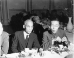 Eating banquet dinner at party at Governor Lung's of Yunnan Province on December 16, 1944. Secretary Liang Yu-kao, and Gen. Liu Ya-yang.  Photo by Pfc. Thomas F. Melvin.  Passed by censor William E. Whitten.