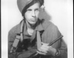 Sgt. Vern P. Martin posing with helmet and carbine in China during WWII.