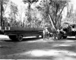 GIs load cut lumber at saw mill in Burma for transport to sites of bridge building.  During WWII.  797th Engineer Forestry Company.