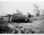 A shot up steam railroad engine, showing large number of bullet or shrapnel holes, derelict in Burma.  During WWII.  797th Engineer Forestry Company.