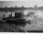 Bulldozer on ferry on river in Burma.  During WWII.  797th Engineer Forestry Company.