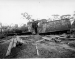 A shot up steam railroad engine, showing large number of bullet or shrapnel holes, derelict in Burma.  During WWII.  797th Engineer Forestry Company.