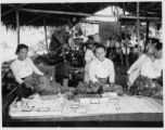 Local people in Burma near the 797th Engineer Forestry Company--ladies selling worked jewels in a market in Burma.  During WWII.