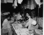 Local people in Burma near the 797th Engineer Forestry Company--A GI visits a jewel shop in Burma.  During WWII.