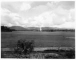 Smoke rising from distance village in Burma.  During WWII.  797th Engineer Forestry Company.