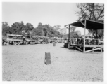 A convoy loaded with troops and engineers prepares to set out, while a band plays, and music projected to convoy via loudspeakers.  During WWII.