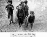 Chinese children, including one who is carrying a baby on his back. During WWII, in SW China.