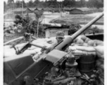 Engineer of the 2005th Ordnance Maintenance Co. working on anti-aircraft gun in India or Burma during WWII.