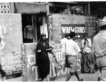 A fakir on the street in India, as an American Black GI walks by, as seen by men of the 2005th Ordnance Maintenance Company, 28th Air Depot Group, in India during WWII.