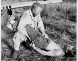 Leo Spearence and John Schuhart (bearded) wrestle on ground. G. I. Clip standing on wing of discarded fighter plane. Likely in Burma. 2005th Ordnance Maintenance Company,  28th Air Depot Group.