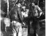 Grease-covered men of the 2005th Ordnance Maintenance Company, 28th Air Depot Group, warming up at burn barrel in Burma. During WWII.