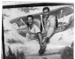 ATC flyers Lt. Bob Boswell and Richard Harris pose in fake prop airplane wall in India, during WWII, in August 1945.