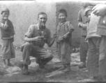 Walter L. Wegner, cigar in mouth, with children in SW China during WWII.