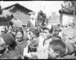 A village protective deity is paraded around the village as part of a festive celebration timed to the lunar calendar.  During WWII.