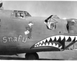 B-24 "Snafu," in CBI during WWII. The GI figure is holding a paper labeled "T. S. Ticket."