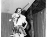 Baton twirling a USO show in Gushkara, India, during WWII.  The boxes in front of the band players are labeled 748th ROB (748th Railway Operating Battalion).