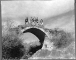 American flyers exploring thin stone bridge at Chanyi (Zhanyi), during WWII.