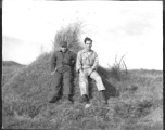 American flyers exploring at Chanyi (Zhanyi), during WWII. They are likely resting on a grave mound.