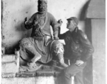 American flyer explore temple and looks at statue at Chanyi (Zhanyi), during WWII.