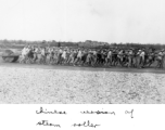 Chinese workers pulling a concrete roller at a field in China, probably in Hunan Province or Guangxi Province. During WWII.