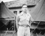 Sgt. David Axelrod, was in the 23rd Fighter Control Squadron from January to August, 1945, stationed at its headquarters at Luliang Airbase, Yunnan, China.  Here he is standing in front of the headquarters tents and building.  