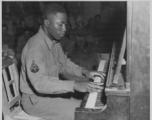 African-American musician playing piano for other GIs in the CBI during WWII.