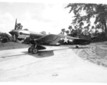 P-40 fighter #65, probably tail #2105234, of the 80th Fighter Group, the “Burma Banshees,” on pavement at an airbase in in Burma during WWII.