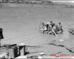 Men ride sheep-skin raft in northern China during WWII, most likely on Yellow River.