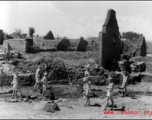 Chinese laborers working around destroyed houses, most likely in Yunnan province.