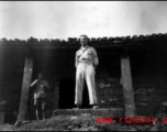 A GI stands in a doorway of a building in China during WWII.