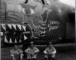 American soldiers sit below the B-24 bomber "Jungle Pussy" in the CBI during WWII.