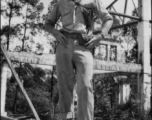 Bob Riese poses amongst remains of aircraft factory and hangers at the air base at Liuzhou, in 1945. The facilities at the base were first destroyed by the Chinese and Americans during retreat in the face of Ichigo during the fall of 1944, then may have been destroyed more by American bombardment during Japanese occupation, and possibly destroyed more by the Japanese as they retreated the area in 1945.