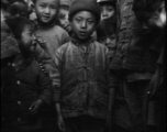 Local people in southern China during WWII: A cool kid in front of the photographer. During WWII.