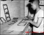 A Chinese work rehabilitates engine gaskets by hand in China during WWII.