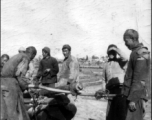 Rural men carry a wooden coffin in SW China during WWII.