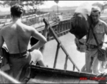 GIs board ship on the way back to the US after the war. The ship is probably the SS Marine Raven.