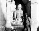 GI poses with Buddhist statuette in the CBI during WWII.