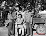 Smiling GIs pose with small child from well-to-do family in China, during WWII.