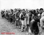 Chinese laborers pulling a large concrete rolling wheel at an air base somewhere in China.  Image from U. S. Government official sources.