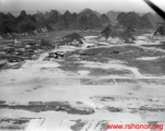 Aerial view of one of the runways at Guilin, Guangxi, China, during WWII.  Notice bomb or demolition holes in runway.  Image from U. S. Government official sources.