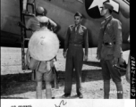 Maj. William H. Makepeace, left, G-3, Y-FOS, and Capt. Shao Lien watch Chinese troops of the Chinese Fifth Army Group board a plane at the Kunming Airport during a troopp movement by air.  Kunming, China, 9/69/44